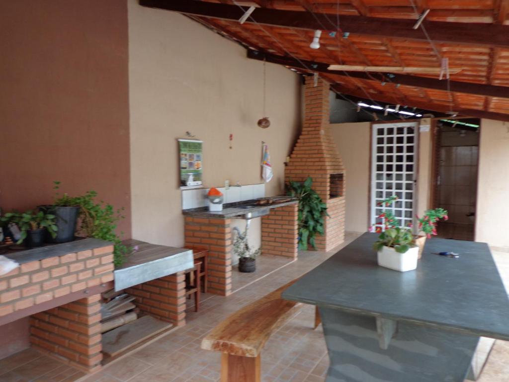 un patio con tavolo e bancone in un edificio di Casa Serra da Canastra - Chicó a São Roque de Minas