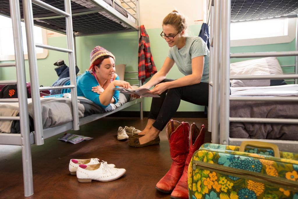 two women sitting on bunk beds with their shoes at HI San Francisco Fisherman's Wharf Hostel in San Francisco