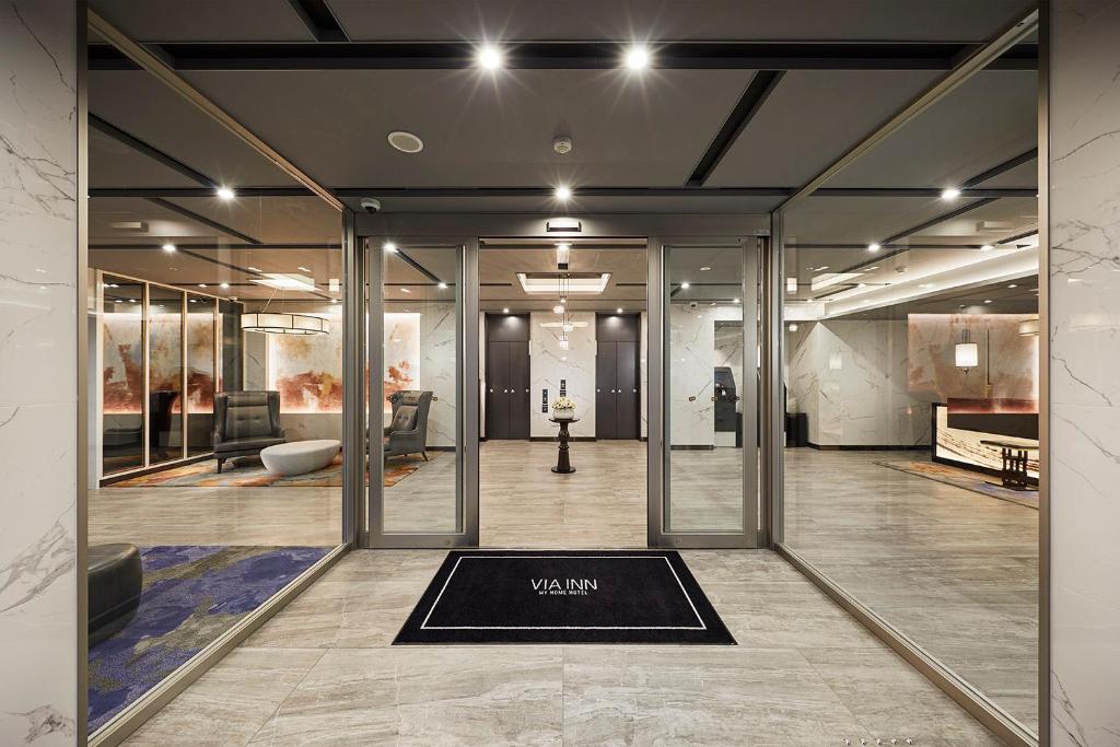 a room with glass doors and a rug on the floor at Via Inn Nagoya Station Tsubaki-cho in Nagoya