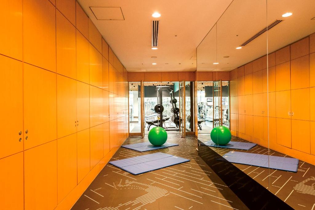 a gym with green pilates balls and pilates equipment at Cerulean Tower Tokyu Hotel, A Pan Pacific Partner Hotel in Tokyo