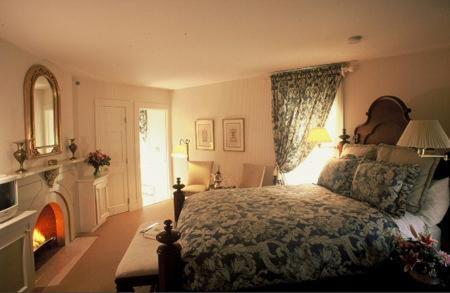 a bedroom with a bed and a fire place at Wynstone Inn in Newport