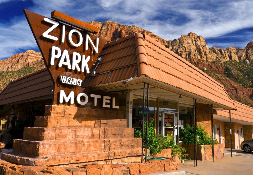 a zion park motel with a mountain in the background at Zion Park Motel in Springdale