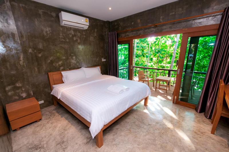 Postel nebo postele na pokoji v ubytování Chiang Klong Riverside Resort