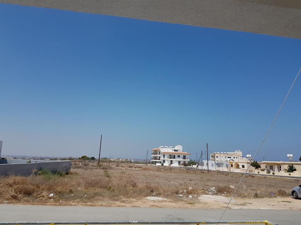 a view of a street with houses in the background at Flora Aparts in Dherinia