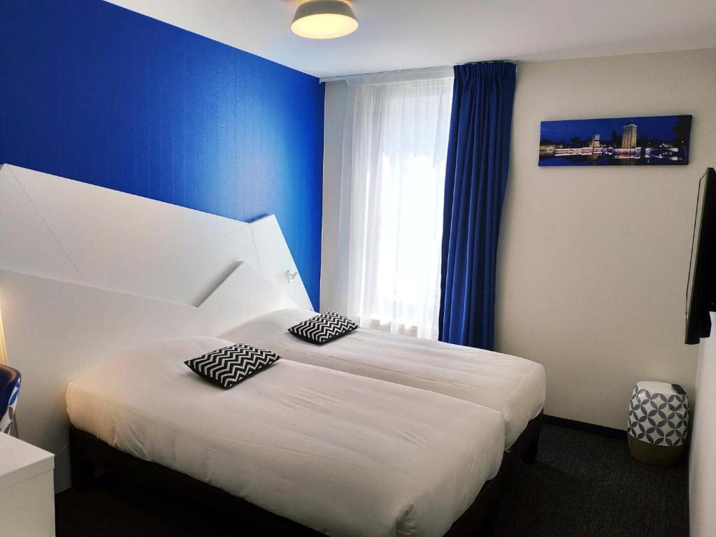 Postel nebo postele na pokoji v ubytování Hôtel ORIGAMI