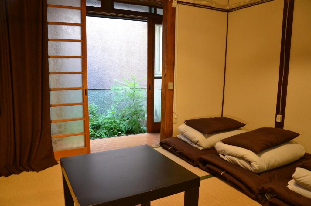 a living room with a couch and a table at Peace house Abeno in Osaka