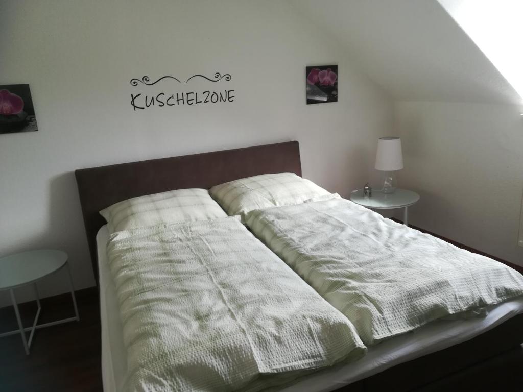 a bed with white sheets on it in a bedroom at Mosel Dream in Cochem
