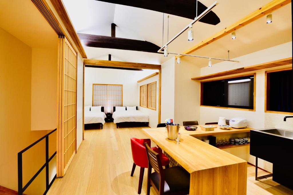 a kitchen and living room with a table and chairs at Cochien Imperial Garden in Kyoto