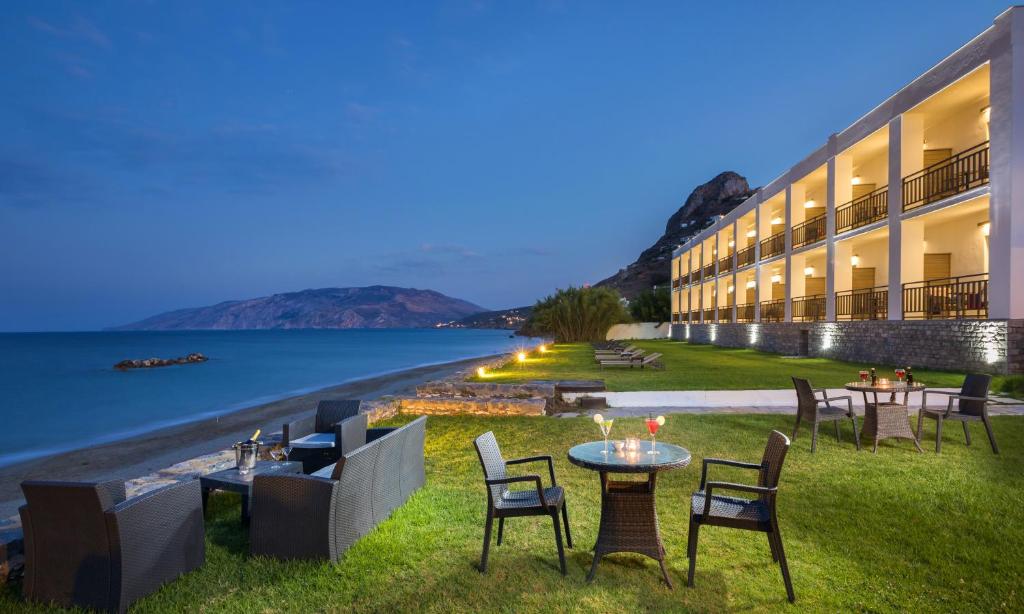 a hotel with a view of the water at night at Hydroussa Skyros in Skiros