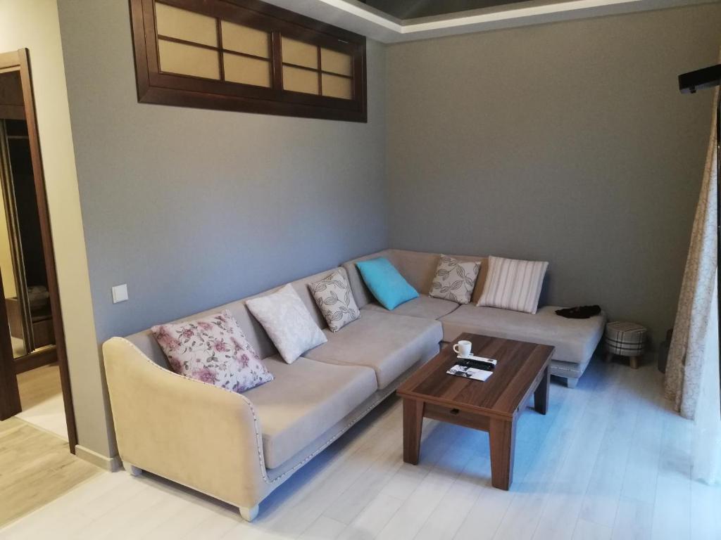 a living room with a couch and a table at Mamuka House in Batumi