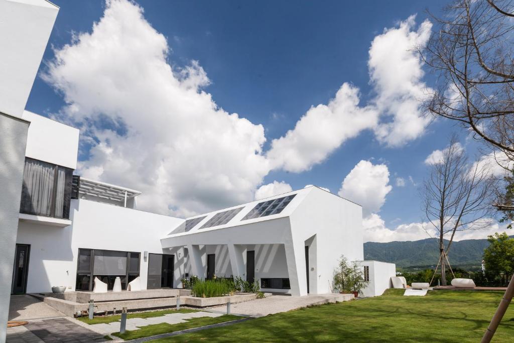 a white house with solar panels on it at FomeStay in Chishang