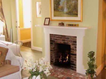 a living room with a fireplace with a fire place at Clarkeston Inn in Newport
