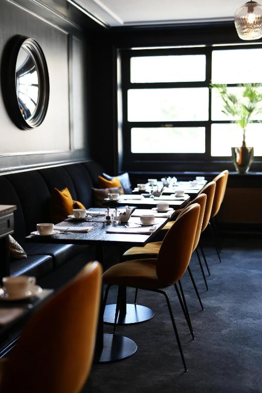 a dining room with a long table and chairs at Hotel Continental in Oslo
