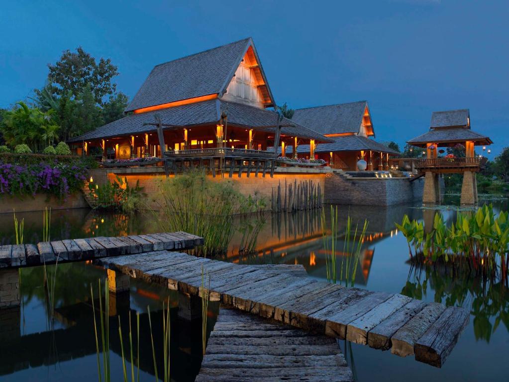 a house on the water with a dock at Howie's HomeStay in Mae Rim