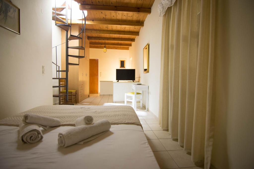 a bedroom with a bed with towels on it at Agapi Holiday Home in Rethymno