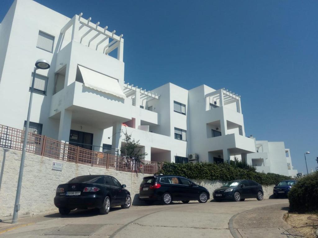 コニル・デ・ラ・フロンテーラにあるCasa Vistas Conil - FAMILIAS Y PAREJASの車が目の前に停まった白い建物