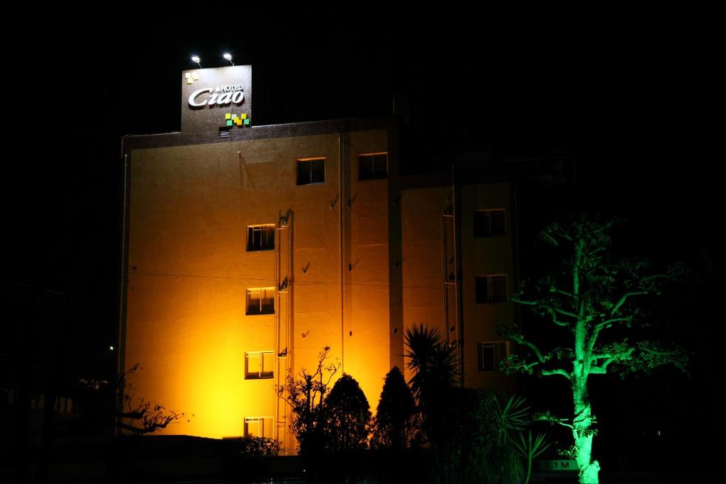 a building with a sign on top of it at night at Ciao-LoveHotel in Miyazaki