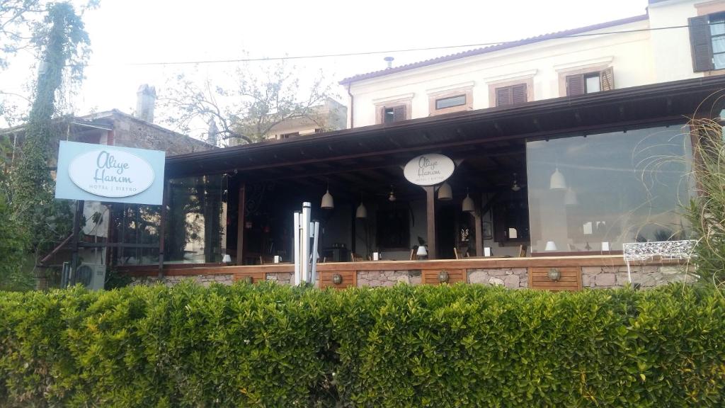 a building with a sign in front of it at Aliye Hanim Hotel in Ayvalık