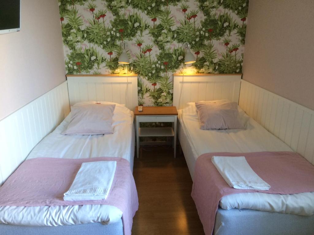 Postel nebo postele na pokoji v ubytování Hotell Paradis