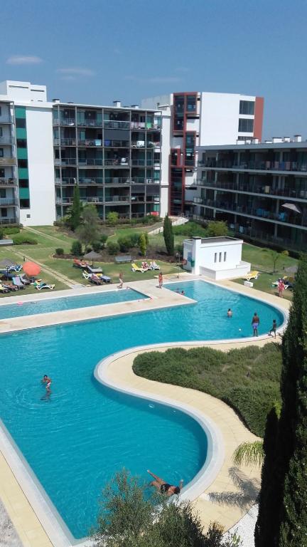 a large swimming pool with people swimming in it at Residence Golf Club, Vilamoura in Vilamoura