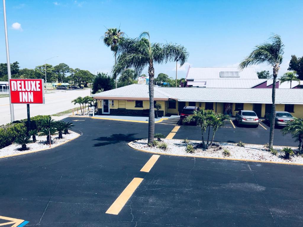 an empty parking lot in front of a motel at Deluxe Inn - Sarasota in Sarasota
