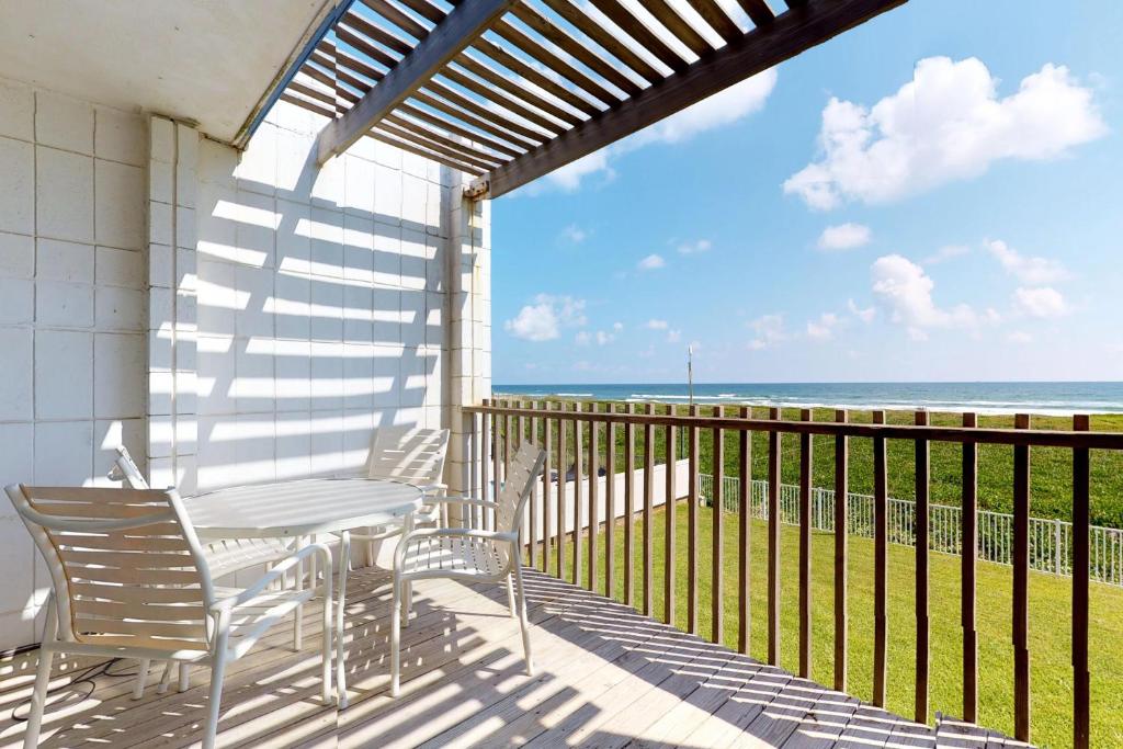 a balcony with chairs and a view of the ocean at La Playa Condominium 209 in South Padre Island