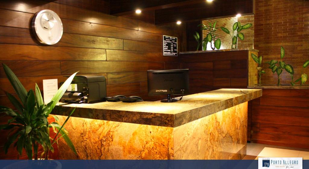 a lobby with a desk with a computer on it at Hotel Porto Allegro Puerto Vallarta in Puerto Vallarta