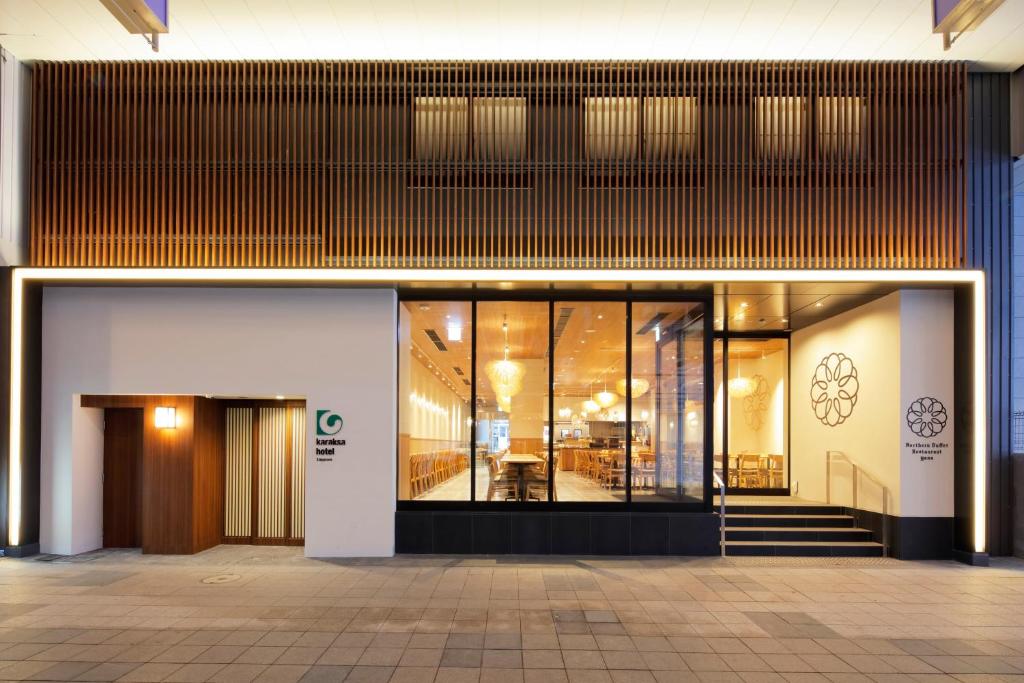 a lobby of a building with a glass door at karaksa hotel Sapporo in Sapporo