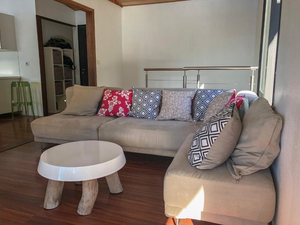 a living room with a couch and a coffee table at La Villa Te Fetia Nui Moorea in Teavaro