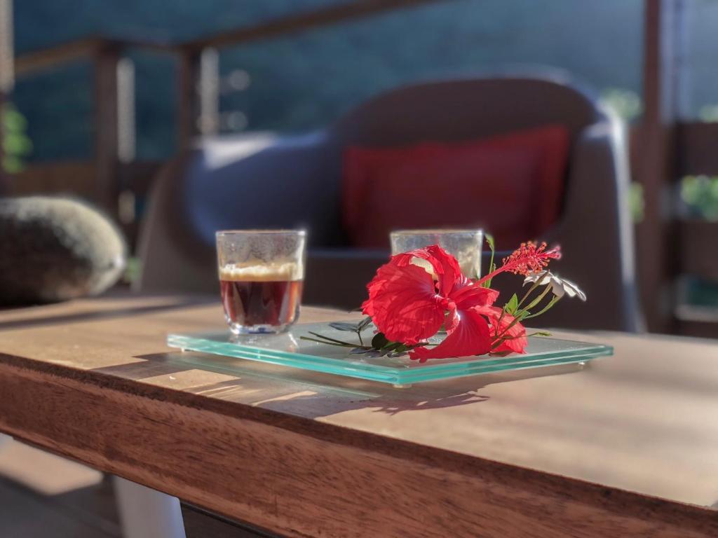 a tray with a drink and a flower on a table at La Villa Te Fetia Nui Moorea in Teavaro