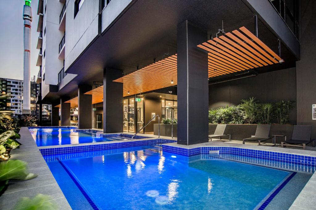 a swimming pool in the middle of a building at Atlas Apartments by CLLIX in Brisbane