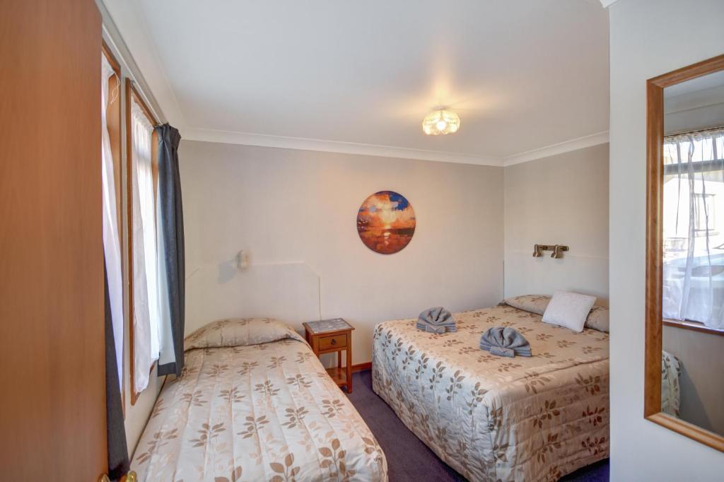 Postel nebo postele na pokoji v ubytování Garden Motel