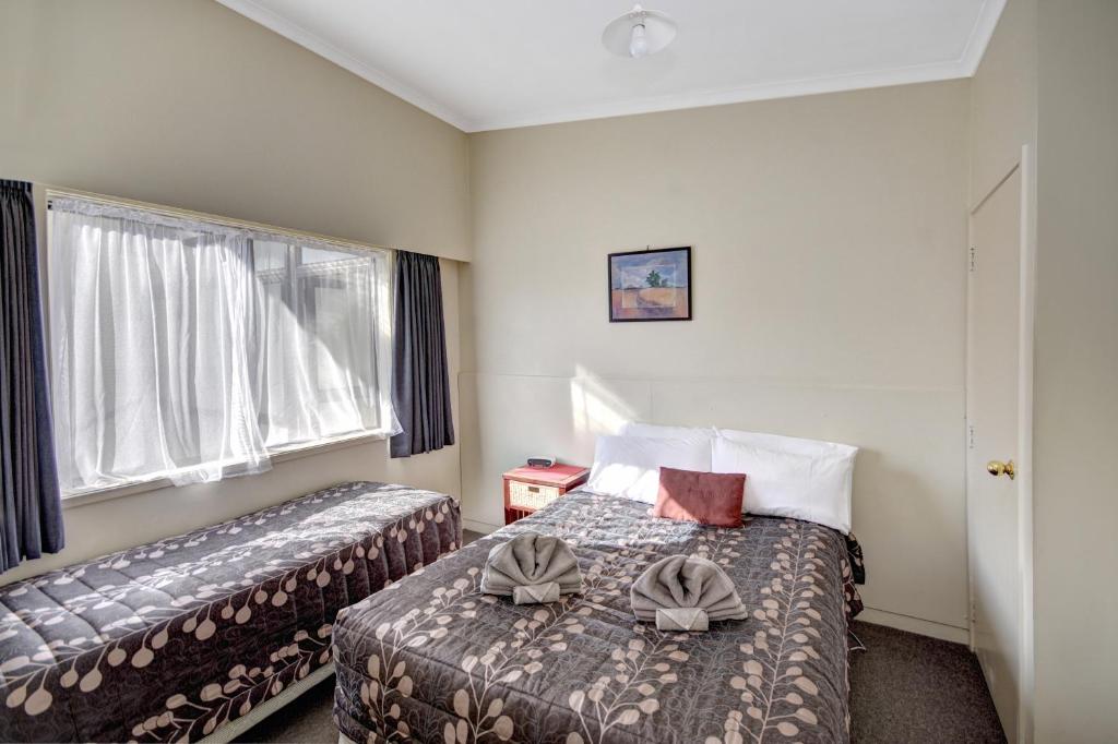 Postel nebo postele na pokoji v ubytování Garden Motel