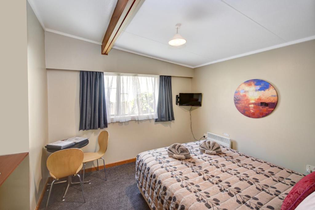 Postel nebo postele na pokoji v ubytování Garden Motel