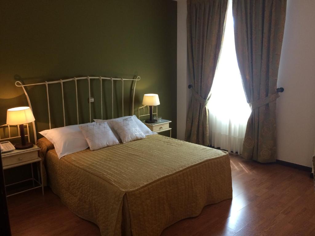 Postel nebo postele na pokoji v ubytování Hotel Villa De Ferias