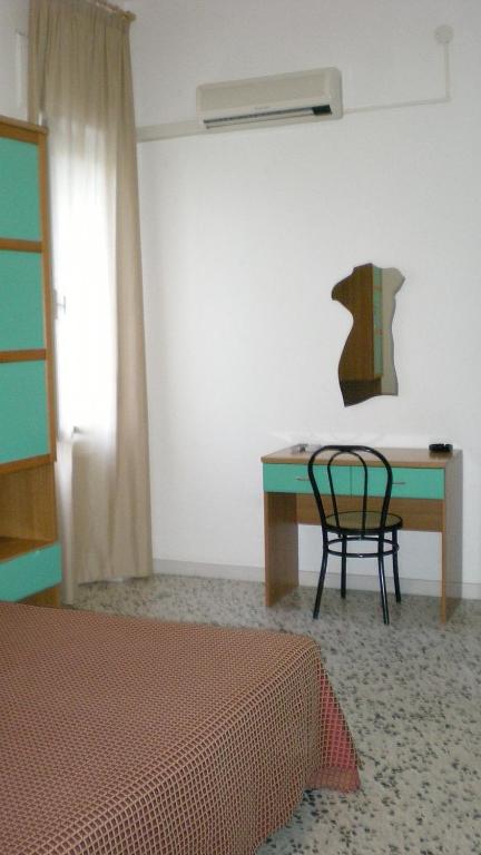 a room with a table and a chair in it at Residence Ducale in Rodi Garganico