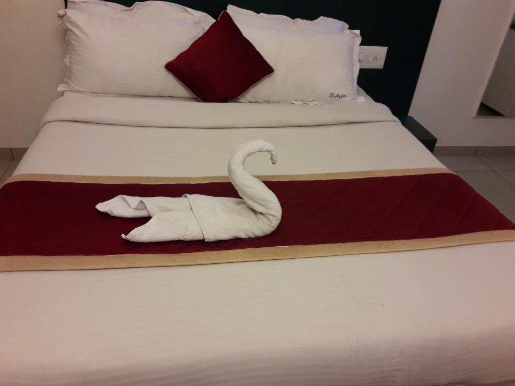 a swan made out of towels on a bed at SAP Golden Grande Electronic City in Bangalore