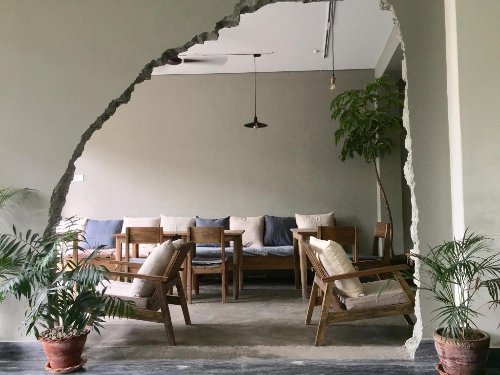 a living room with a table and chairs at Hotel Blossom in Pokhara
