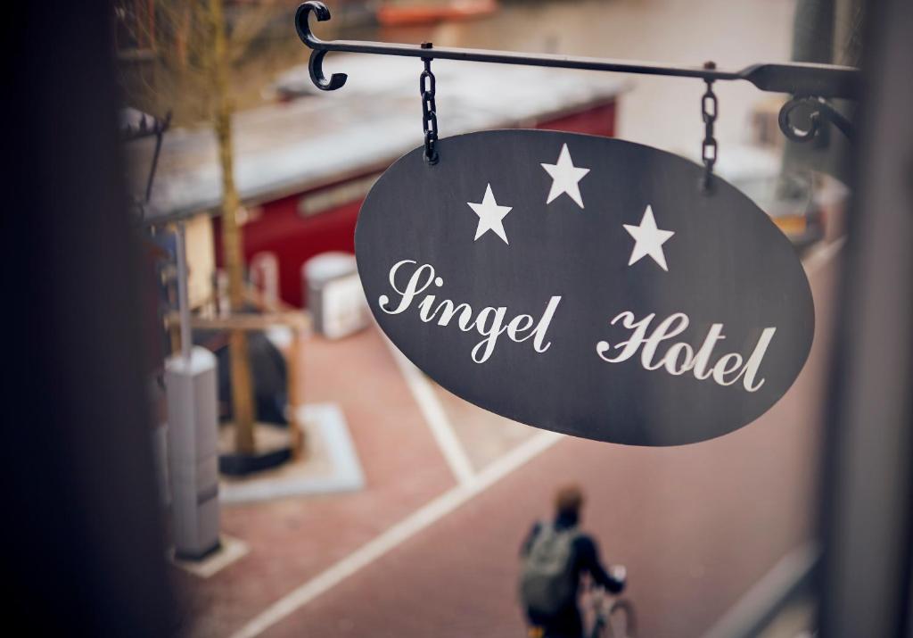 a sign that reads wrapped hated hanging from a building at Singel Hotel Amsterdam in Amsterdam