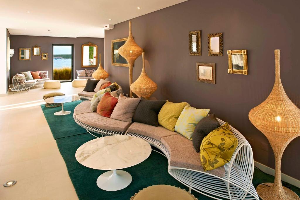 a living room with a couch and a table at Martinhal Sagres Beach Family Resort Hotel in Sagres