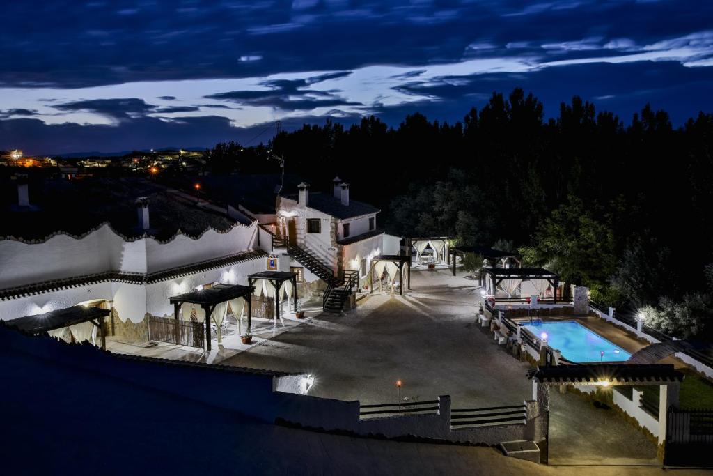an aerial view of a house with a swimming pool at night at Cuevas El Moral in Castilléjar