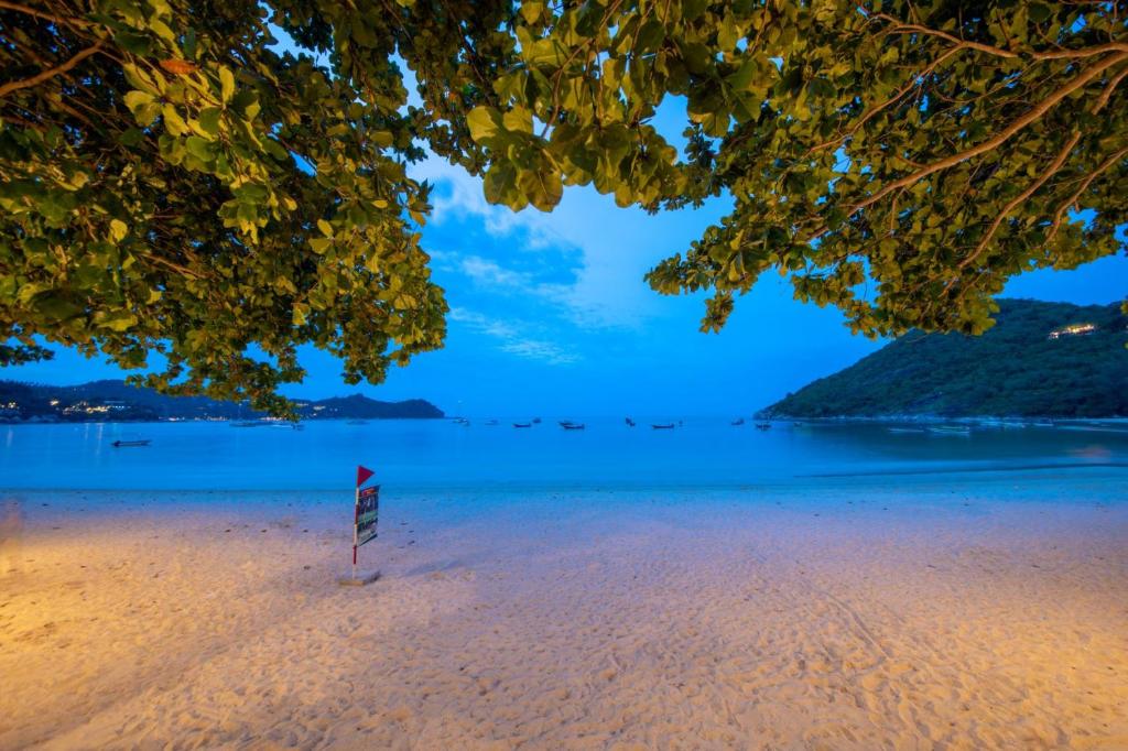 a view of a beach with a sign on it at Thong Nai Pan Beach Residence in Thong Nai Pan Yai