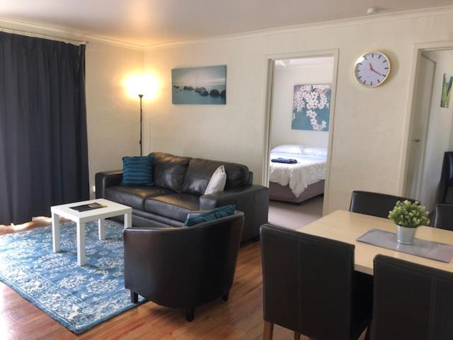 
a living room filled with furniture and a table at Willow Dene Holiday Apartments in Bright
