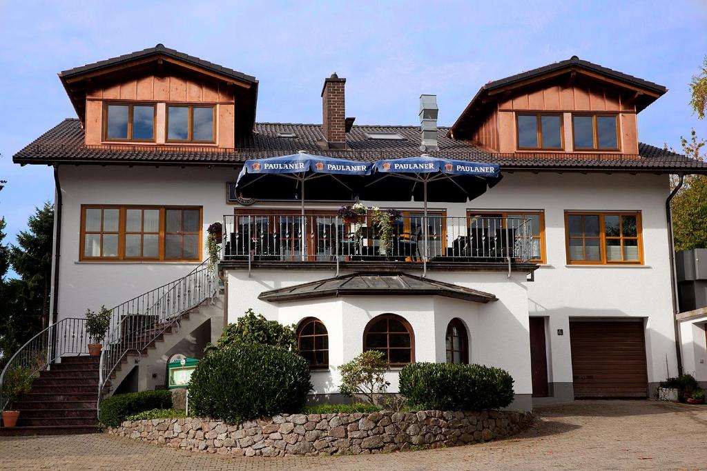 a large white house with an umbrella in front of it at Haus am Mühlberg in Modautal