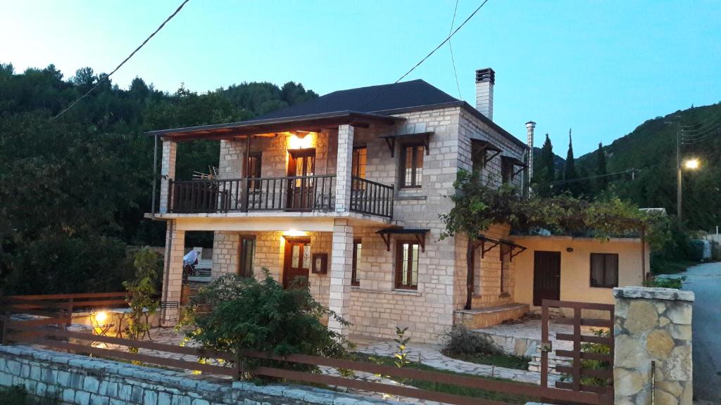a large brick house with a balcony on top of it at To Archontiko tis Nikis in Ioannina