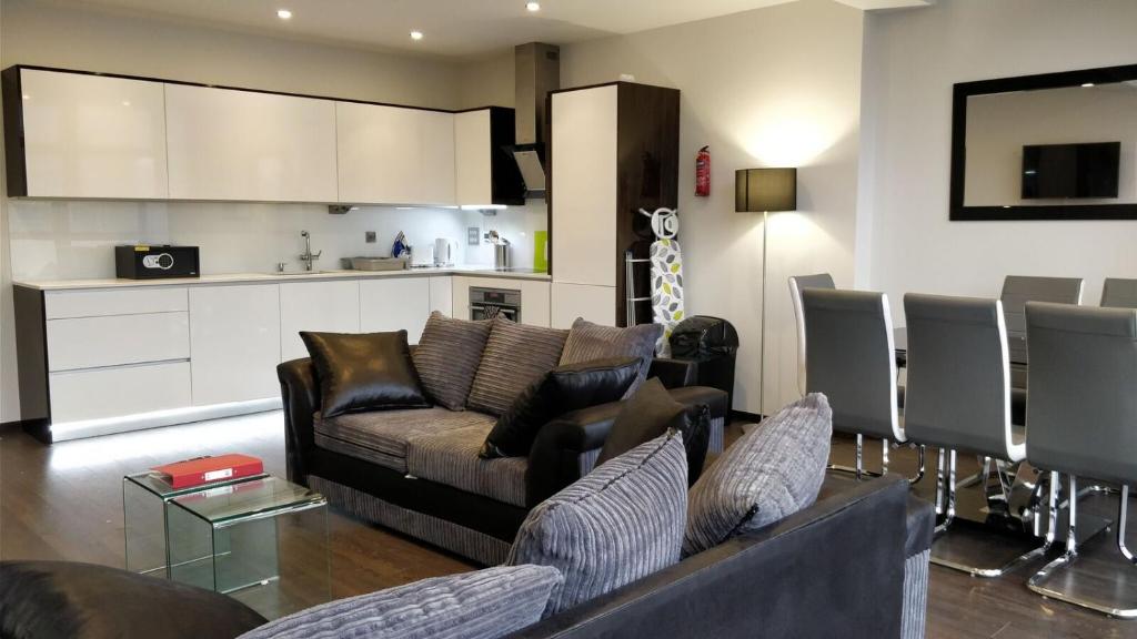 a living room with a couch and a kitchen at Access Tower Hill in London