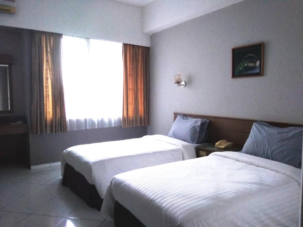 Postel nebo postele na pokoji v ubytování K-Style Eco Hotel Jakarta