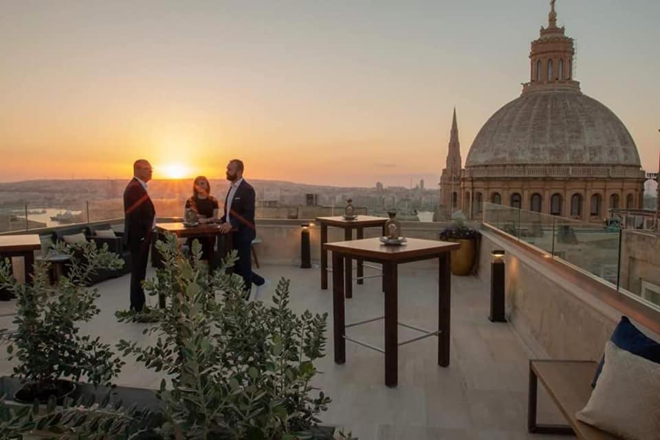 a group of people standing on the roof of a building at The Manoel Boutique Hotel in Valletta