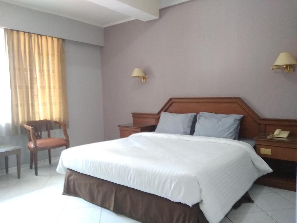 Postel nebo postele na pokoji v ubytování K-Style Eco Hotel Jakarta