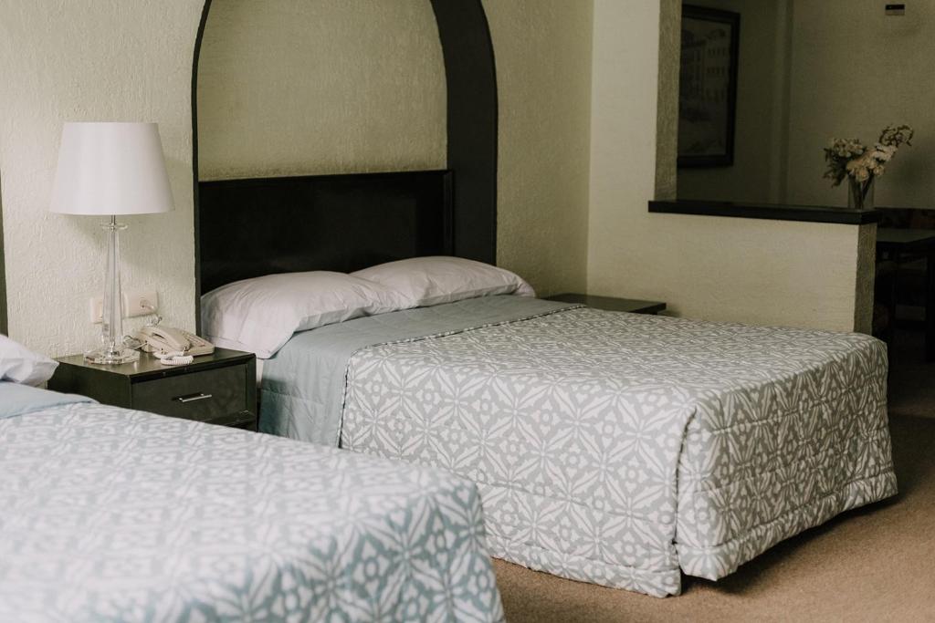 Postel nebo postele na pokoji v ubytování Hotel Leon